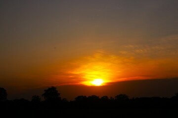 Sunset Sky Clouds in the evening with Red, Orange, Yellow and purple sunlight on Golden hour after sundown, Romantic sky in summer on Dusk Twilight. heart sky.