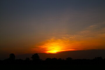 Sunset Sky Clouds in the evening with Red, Orange, Yellow and purple sunlight on Golden hour after sundown, Romantic sky in summer on Dusk Twilight. heart sky.