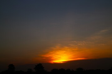 Sunset Sky Clouds in the evening with Red, Orange, Yellow and purple sunlight on Golden hour after sundown, Romantic sky in summer on Dusk Twilight. heart sky.