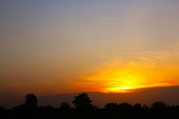 Sunset Sky Clouds in the evening with Red, Orange, Yellow and purple sunlight on Golden hour after sundown, Romantic sky in summer on Dusk Twilight. heart sky.