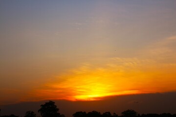 Obraz premium Sunset Sky Clouds in the evening with Red, Orange, Yellow and purple sunlight on Golden hour after sundown, Romantic sky in summer on Dusk Twilight. heart sky.