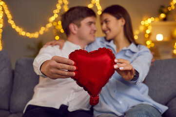People in love, man and woman holding red heart symbol, happy romantic Valentine day emotion....