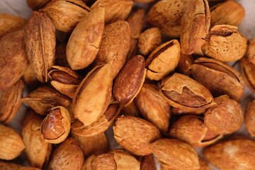 roasted almonds. Almonds are part of the Prunoidae subfamily of the Rosaceae family. This plant is in the same classification as peaches in the subgenus Amygdalus within Prunus. Prunus dulcis