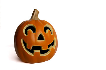 Carved jack o lantern pumpkin with smiling face against white background 