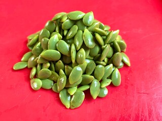 Leucaena isolated on red background. In Indonesia, it is usually consumed by processing it into various kinds of food menus