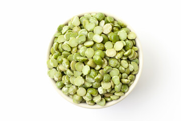 Uncooked, green peas in bowl on white background. Top view