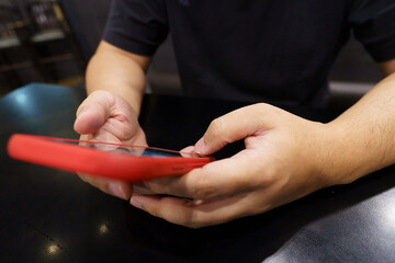 Man playing game on mobile phone. gamer boy playing video games holding Smartphone working mobile devices. cell telephone technology e-commerce concept.