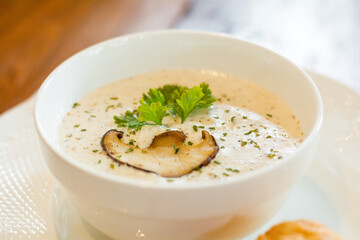 Italian food concept. Delicious champignon mushroom white cream soup in a bowl.