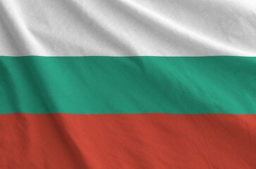 Bulgaria flag depicted on folded wavy fabric of old cloth close up