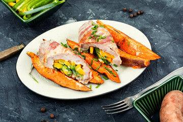 Pork roll filled and baked sweet potatoes.