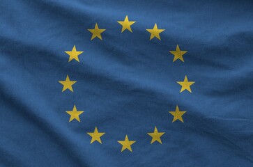 European union flag depicted on folded wavy fabric of old cloth close up
