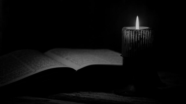  Open Bible And Burning Candle In Black And White Display.