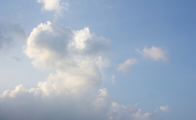 It's a blue sky with atmospheric puffy clouds