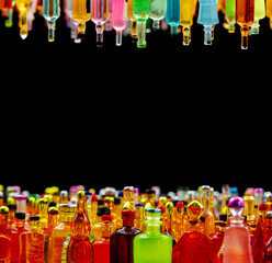 various miniature bottles of alcohol without labels with black bacground