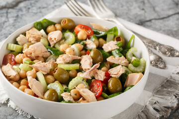 Chickpea tuna salad that's filled with bright flavor and fresh ingredients like tomatoes, celery, spinach and homemade dressing close-up in a bowl on the table. Horizontal