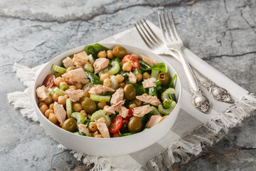 Delicious chickpea tuna salad with healthy ingredients like fresh vegetables and herbs close-up in a bowl on the table. Horizontal