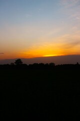 Sunset Sky cloud in the Morning Sunrise with Orange, Yellow Golden Hour Sunrise on Summer season, Horizon Dusk Sky Dramatic Nature Background