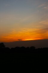Sunset Sky cloud in the Morning Sunrise with Orange, Yellow Golden Hour Sunrise on Summer season, Horizon Dusk Sky Dramatic Nature Background