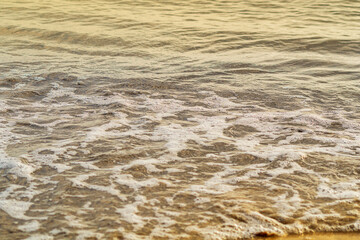 Foamy surface of sea water near sandy coast, at sight of sound of sea surf and the sound of seagulls immediately arises in head. Screensaver, photo wallpapers for relaxing psychological practices