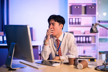 Overworked young Asian businesswoman office worker suffering from neck pain after had a long day at...