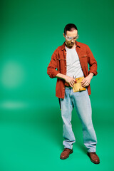 A handsome male worker in uniform, posing with tools on a vibrant green backdrop.