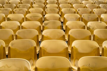 Fototapeta premium Empty stands and seats for fans and fans in the open-air stadium. Lack of fans during the pandemic.. Beautiful simple AI generated image in 4K, unique.