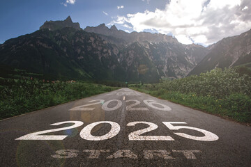 2025, the new year 2025 or the beginning of the concept of the word 2025, written on a road in the middle of a paved road with a sunset mountain backdrop Planning ideas and challenges