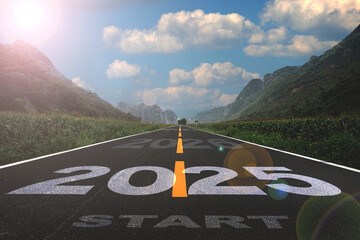2025, the new year 2025 or the beginning of the concept of the word 2025, written on a road in the middle of a paved road with a sunset mountain backdrop Planning ideas and challenges