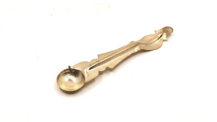 vintage copper spoon used for pooja rituals in temple worship isolated on white background