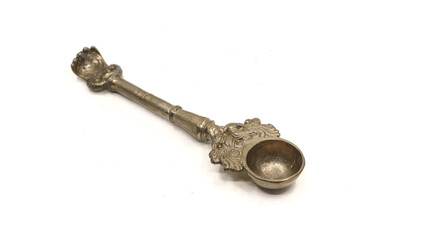 antique handcrafted bronze spoon used for pooja rituals isolated on white background