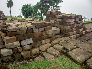 piles of ancient stones in the park area which are the ruins of temples in the past