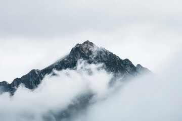 Obraz premium Snow-Capped Mountain Above Clouds