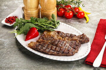 Grilled chuck roll steak with arugula