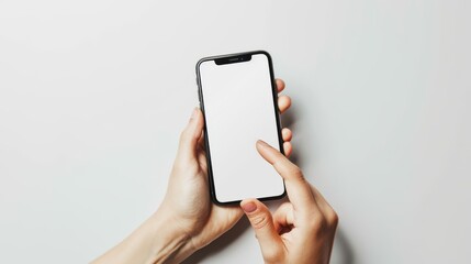 A person is holding a cell phone with a white screen. The phone is being used to make a call