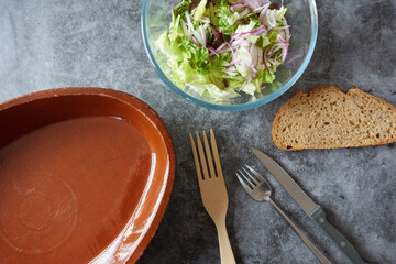 Topview of empty clay baking dish and lettuce salad