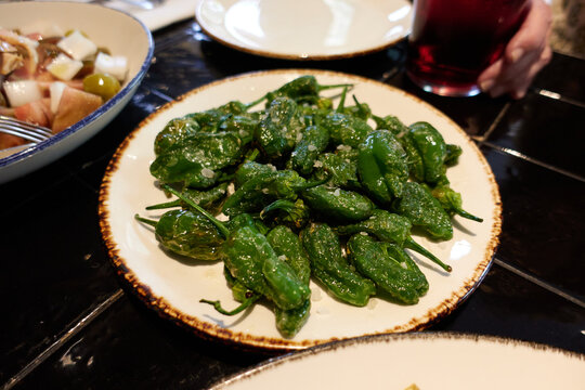 White plate with padron peppers
