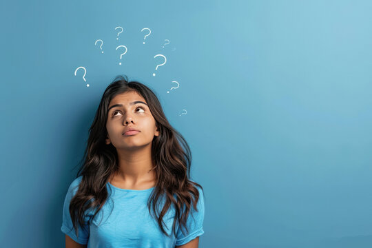 young indian girl thinking with question mark
