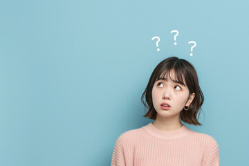 young beautiful girl thinking with question mark