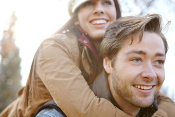 Fototapeta premium Relationship, couple and smile in forest with piggyback for bonding, support and trust in Germany. Love, people and happy in outdoor or woods for holiday, sightseeing and adventure in winter