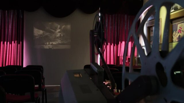 old film machine projects black and white film onto the screen