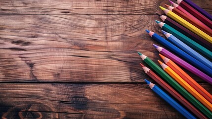 Fototapeta premium Color pencils on a wooden table with empty space