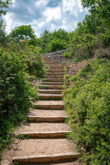 the hiking trail with steep steps up to the top of the Roche de Solutre