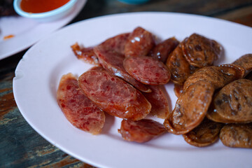 Close up Chinese sausage fried on a food plate, a food simple and delicious.