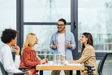Professionals engage in a lively meeting at an office table.