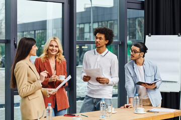 A diverse group of professionals engaged in a discussion at a meeting table.