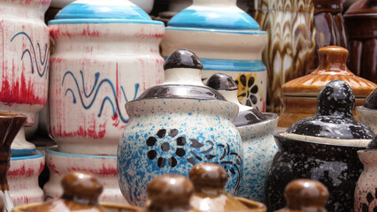 Colorful ceramic crockery items displayed in a shop