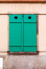 Closed Green Shutters on Pink Wall