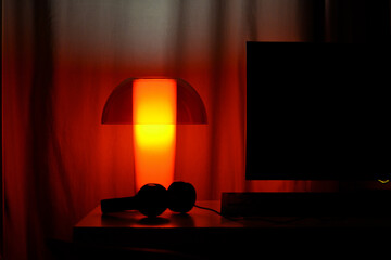 A red lamp on a table.