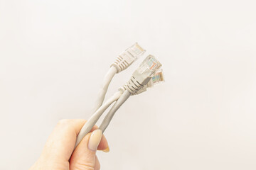 Woman holds internet wires with connectors. Network cables