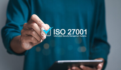 ISO 27001 concept. requirements, certification, management, standards. Businessman using tablet to...